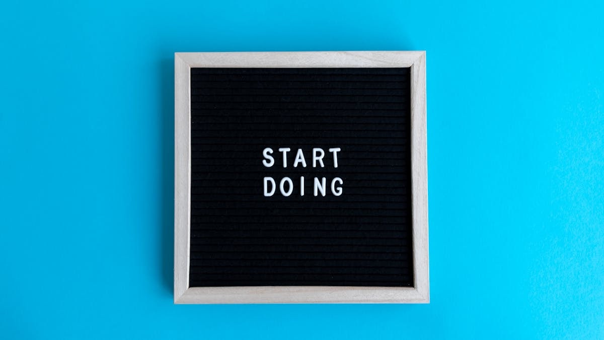Black letter board with 'START DOING' text on a vibrant blue background.